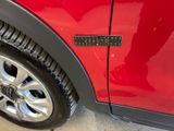 a close up of a red car with a sticker on it