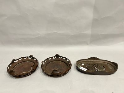 three antique metal trays on a white background