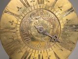 an image of a gold clock with roman numerals on the face