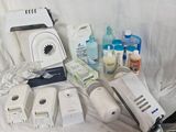 a table with a bunch of items that include a blender, a bottle of water, a toothbrush, a toothpaste and a toothbrush