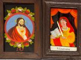 two paintings of jesus and mary in a wooden frame on a wall