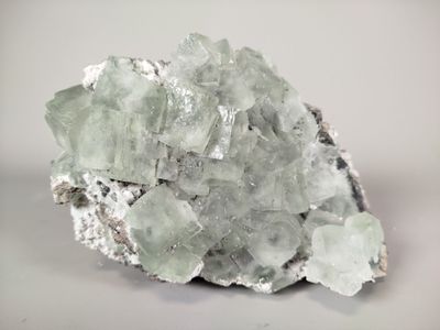 a large piece of rock with a lot of green crystals on it