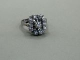 an image of a diamond ring sitting on a white surface