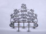 a close up of a metal sculpture of a window with flowers on it