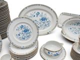 a lot of plates and bowls that are sitting on a table
