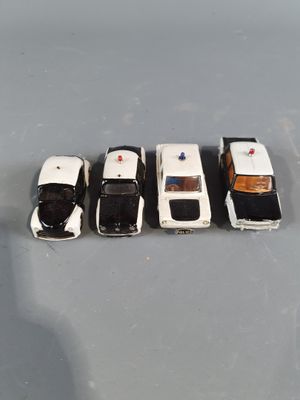 several toy cars are lined up in a row on a gray surface