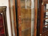 a glass display case in the corner of a room