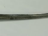 a very old dagger on display on the table