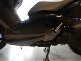 a black motorcycle that is parked in a showroom