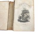 an old book with a picture of a man and a dog on it