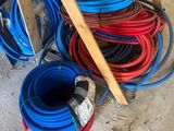 a pile of hoses sitting on the floor next to a ladder