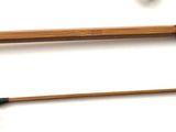 two fishing rods and a fishing rod on a white surface