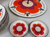 many plates with flowers on them on a table