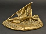statue of a man on a boat with a dog in the water