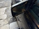 a black car parked on the side of the street