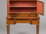 an antique wooden desk with two drawers and a door open