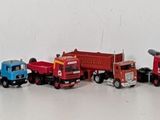 many toy cars that are lined up on the wall