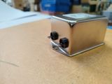 a silver toaster sitting on top of a wooden table