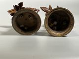 two vases that are sitting on a table