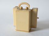 a small yellow suitcase with a handle on a white surface