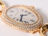 an image of a gold watch with a diamond bezeled face