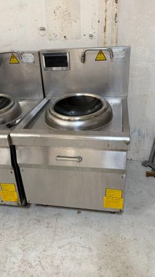 two washers sitting next to each other in a dirty room
