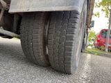 a close up of a flat tire on a truck