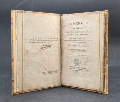 an open book with writing on it sitting on top of a table
