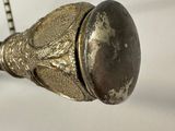 a metal object with a chain around it