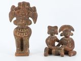 two figurines of a man and a woman sitting next to each other