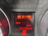 a car dashboard with a speedometer and a red light