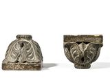 two small vases are sitting next to each other on a white surface