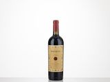 a bottle of red wine sitting on top of a table