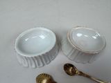 two bowls and spoons sitting on a table