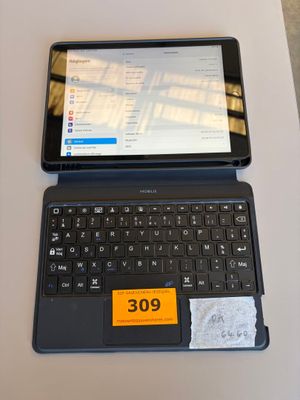 a laptop computer sitting on a table with a price tag on it