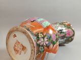 pair of chinese vases with floral designs on them on a white surface