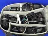 a camera bag filled with many different types of cameras