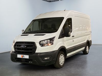 the white van is parked in the large room of the building