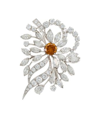 an orange and white diamond broochle, by van cleef