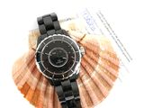 a picture of a black watch on a seashell
