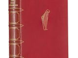 a red book with gold trim and a harp on the cover