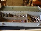 a metal box with tools in it sitting on a table