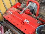 a red machine that is sitting in a pile of junk