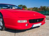 a red sports car parked in a parking lot