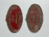 an image of two old tokens that are on a white surface