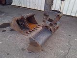a bulldozer that is sitting on the ground in front of a building