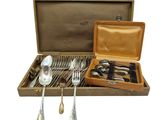 a box with silverware in it on a white background
