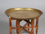 a gold tray on a wooden table on a white background