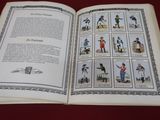 an open book with pictures of people on it on a table