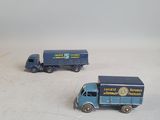 three toy trucks that are sitting on a white surface